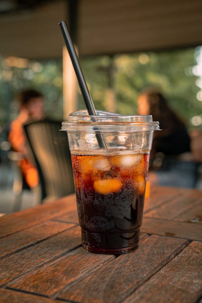 Enjoy a chilled iced coffee outdoors in a sunny cafe